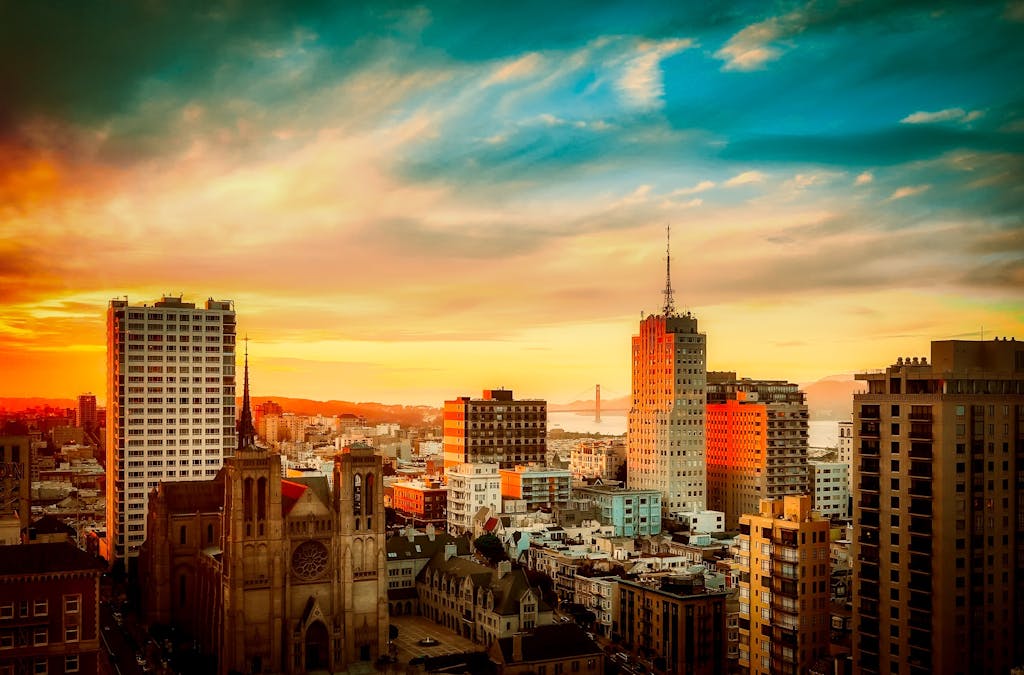 Stunning view of San Francisco cityscape with Golden Gate Bridge at sunset, vibrant urban atmosphere.